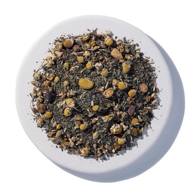 Tea leaves in a white bowl on a white background