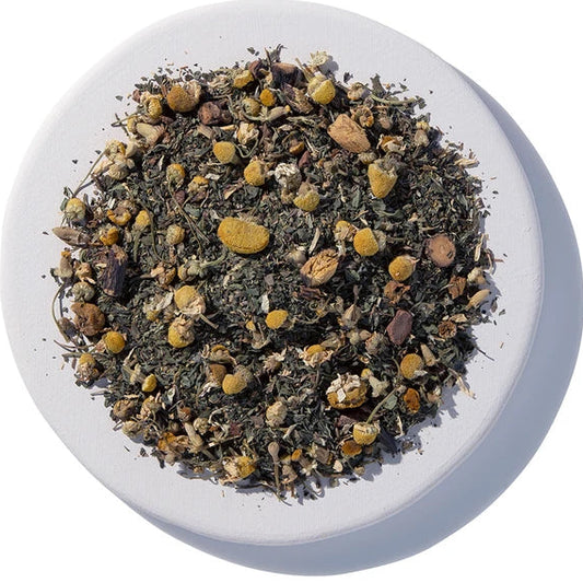 Tea leaves in a white bowl on a white background Afternoon Delight Organic Herbal Tea