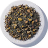 Tea leaves in a white bowl on a white background Afternoon Delight Organic Herbal Tea
