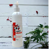 A white pump bottle of our tiger roar body lotion against a wood background