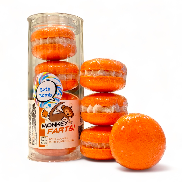 A stack and tube of orange milo monkey bath cookies against a white background