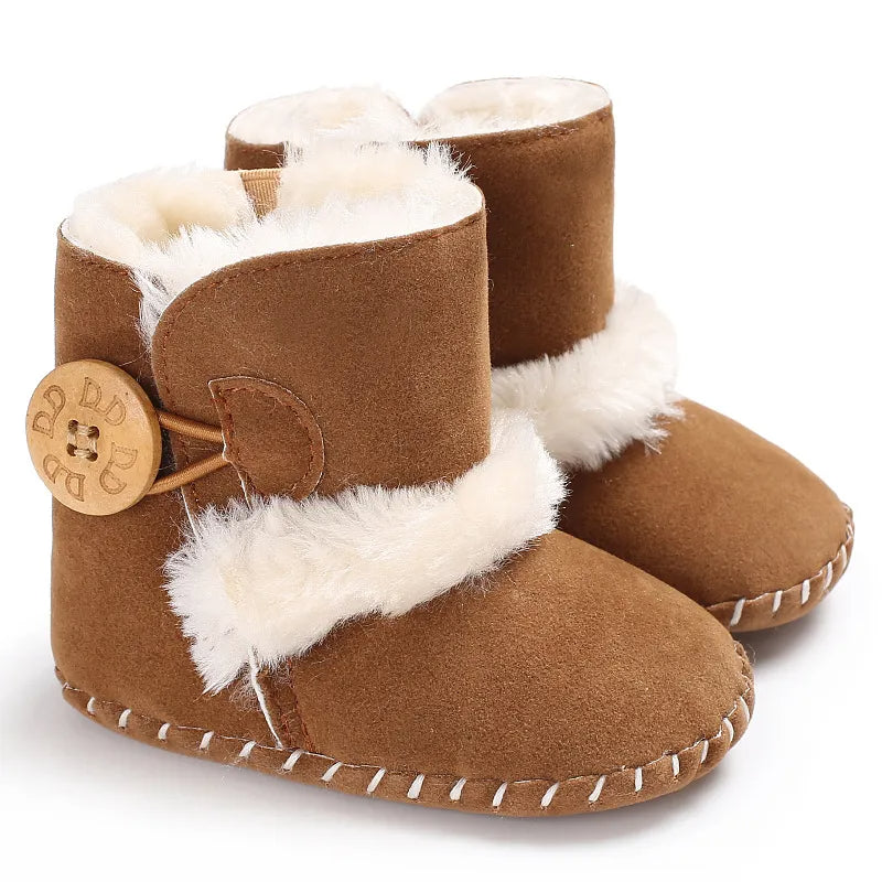 Pair of brown baby boots with white fur trim on a white background