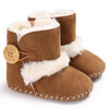 Pair of brown baby boots with white fur trim on a white background