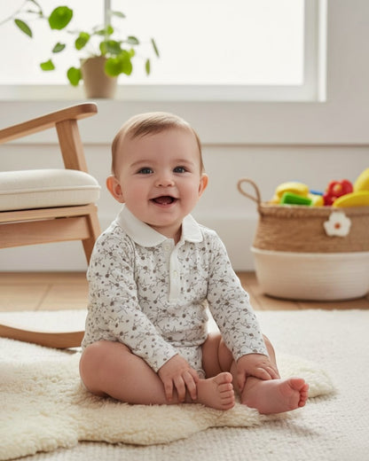 Baby sitting on a rug in a room with a rocking chair and plants.