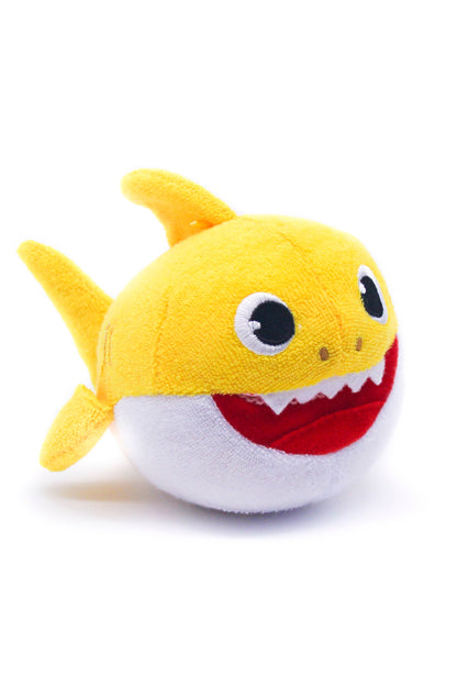 Plush toy shark with a yellow body, black eyes, and red mouth on a white background