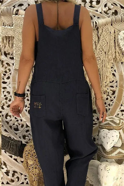 Person wearing a black jumpsuit with a decorative background