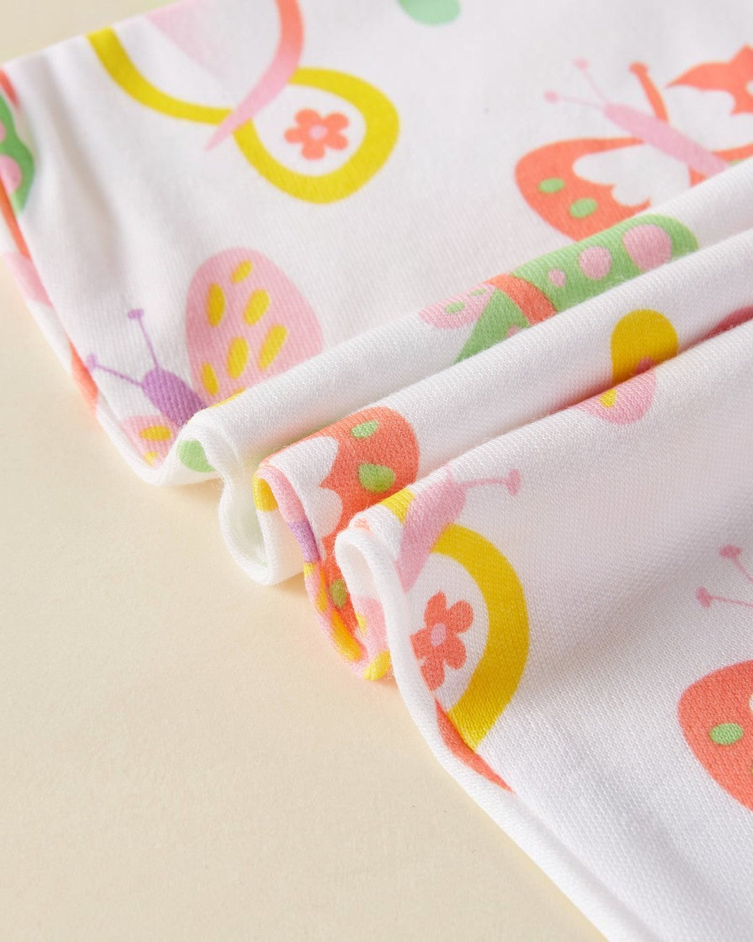 Close-up of colorful fabric with butterfly pattern on a beige background