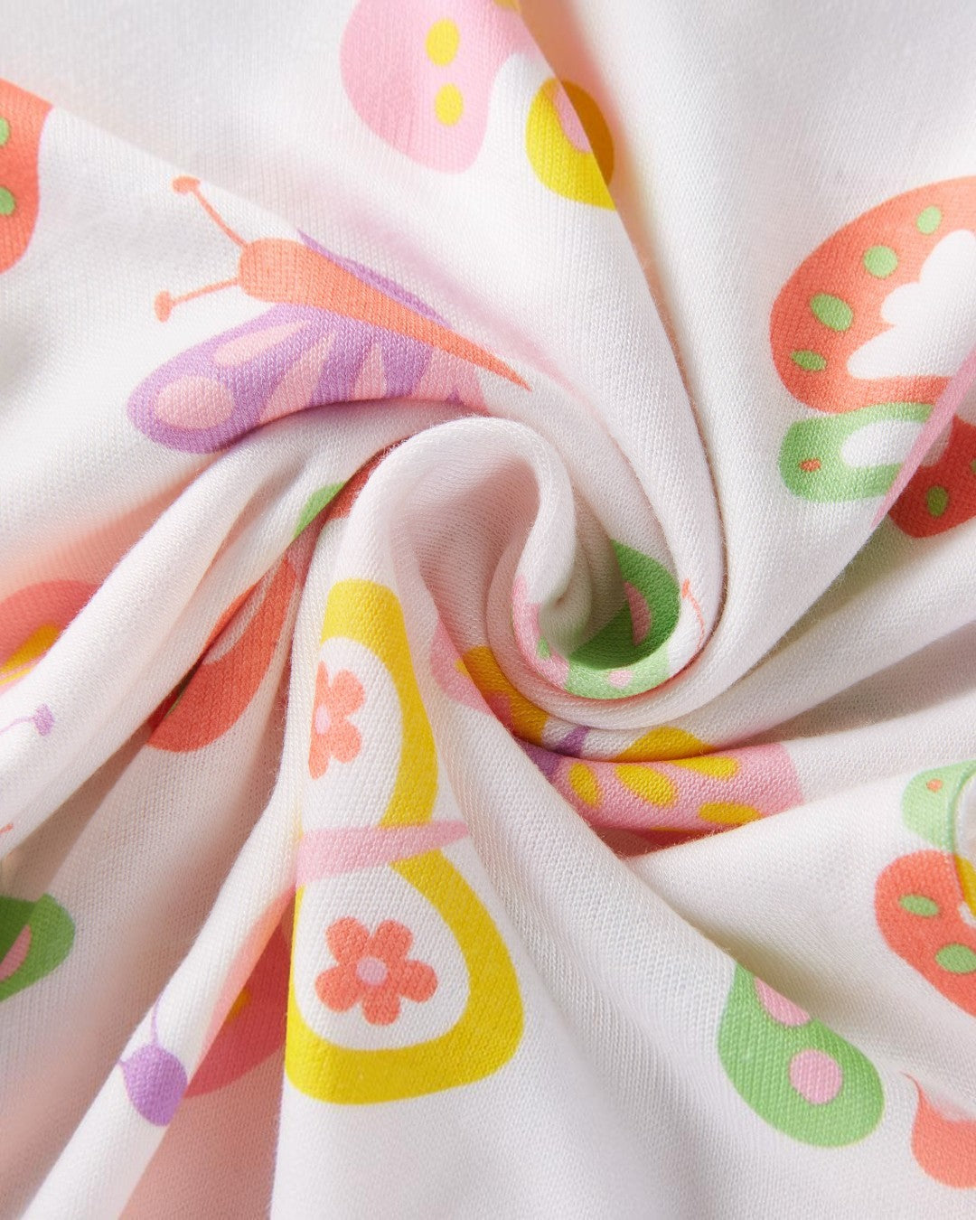 Roll of fabric with colorful butterfly pattern on a white background
