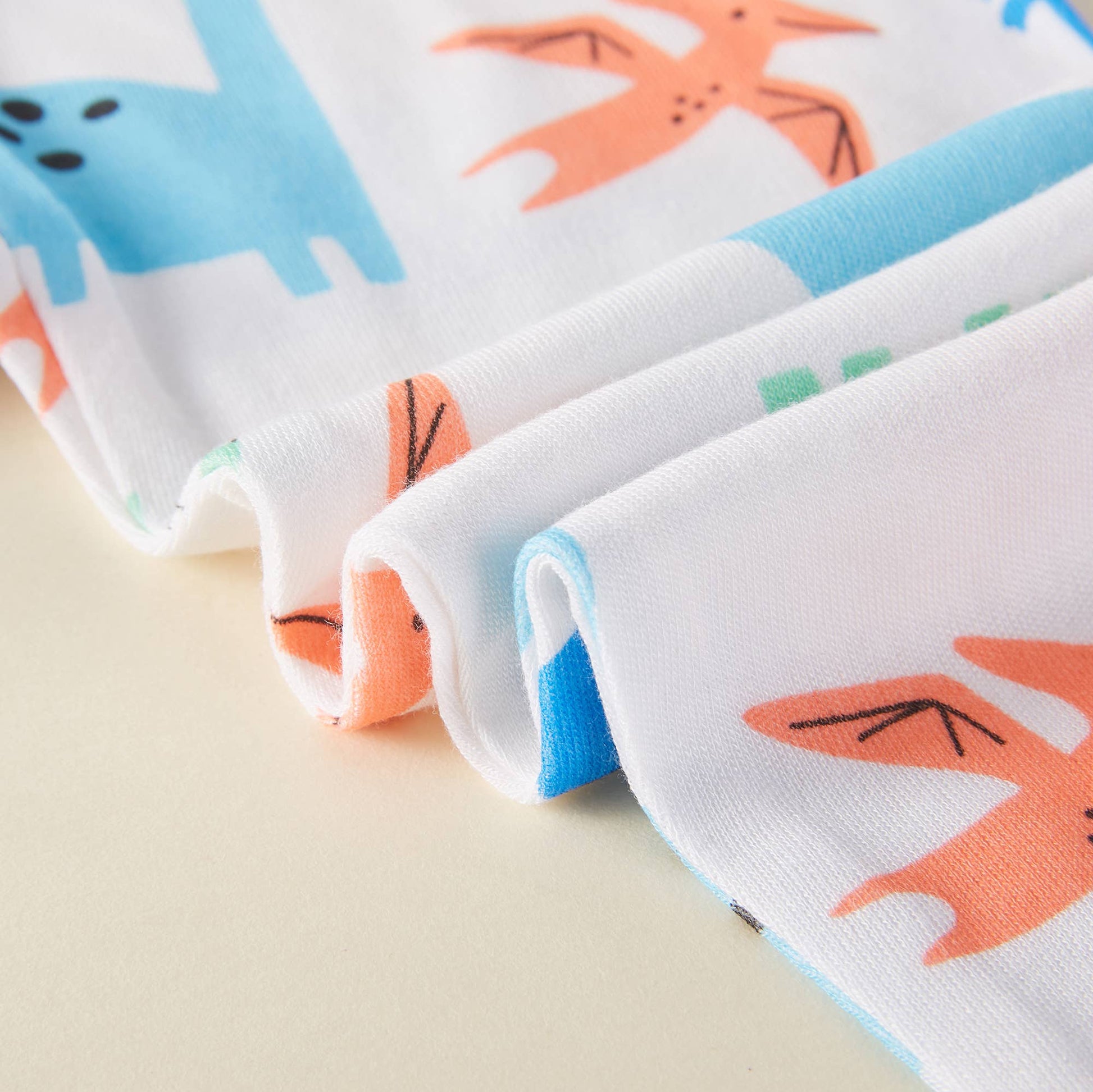 Folded fabric with cartoon fox pattern on a beige background