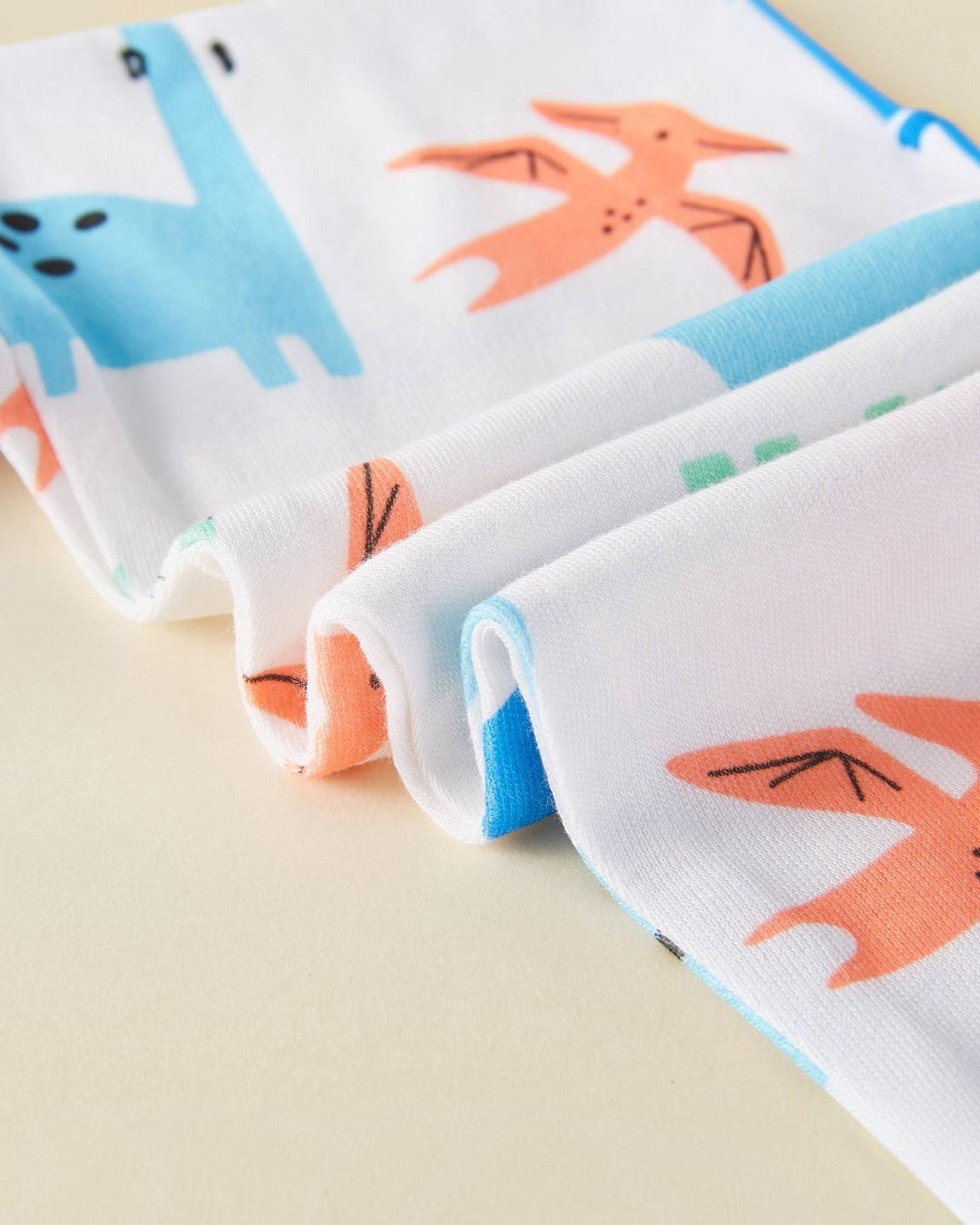 Folded fabric with cartoon fox pattern on a beige background