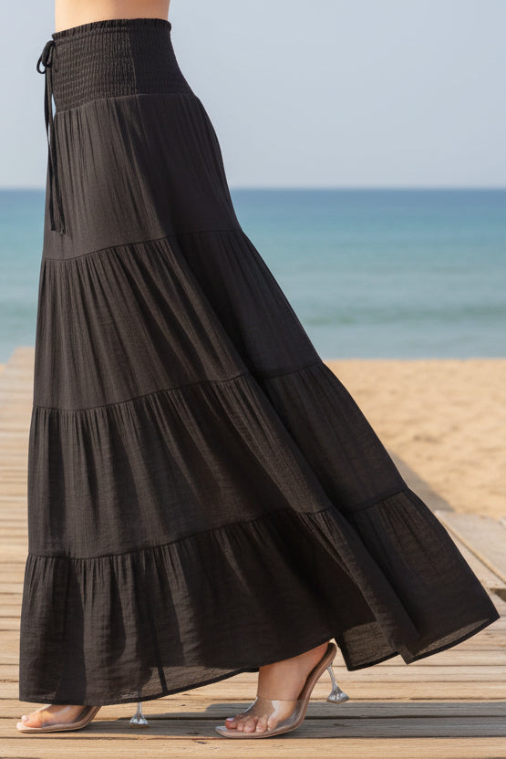 Black tiered maxi skirt on a white background