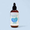 Calla Lily green tea lotion bottle with a heart design on a light blue background. Blackberry Magnolia Cream Lotion