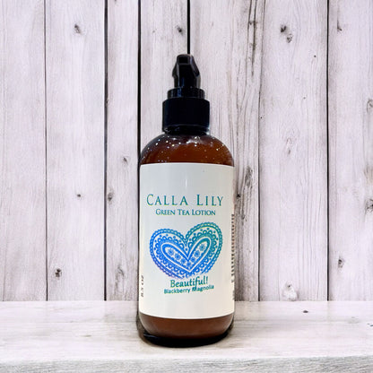 Bottle of Calla Lily Green Tea Lotion on a wooden surface. Blackberry Magnolia Cream Lotion
