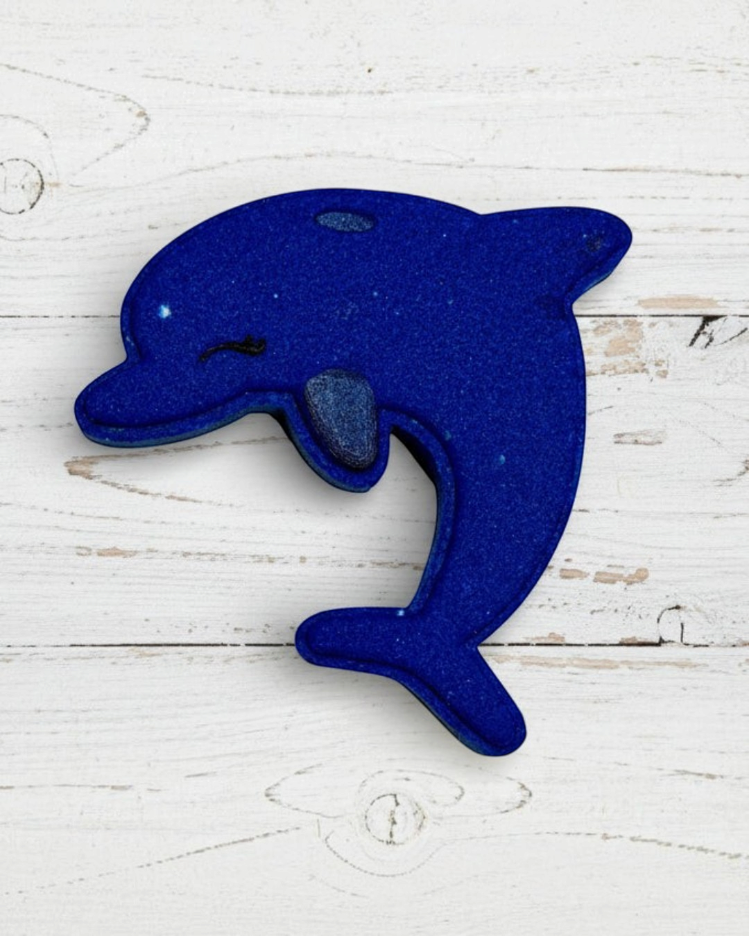 Blue dolphin-shaped object on a white background