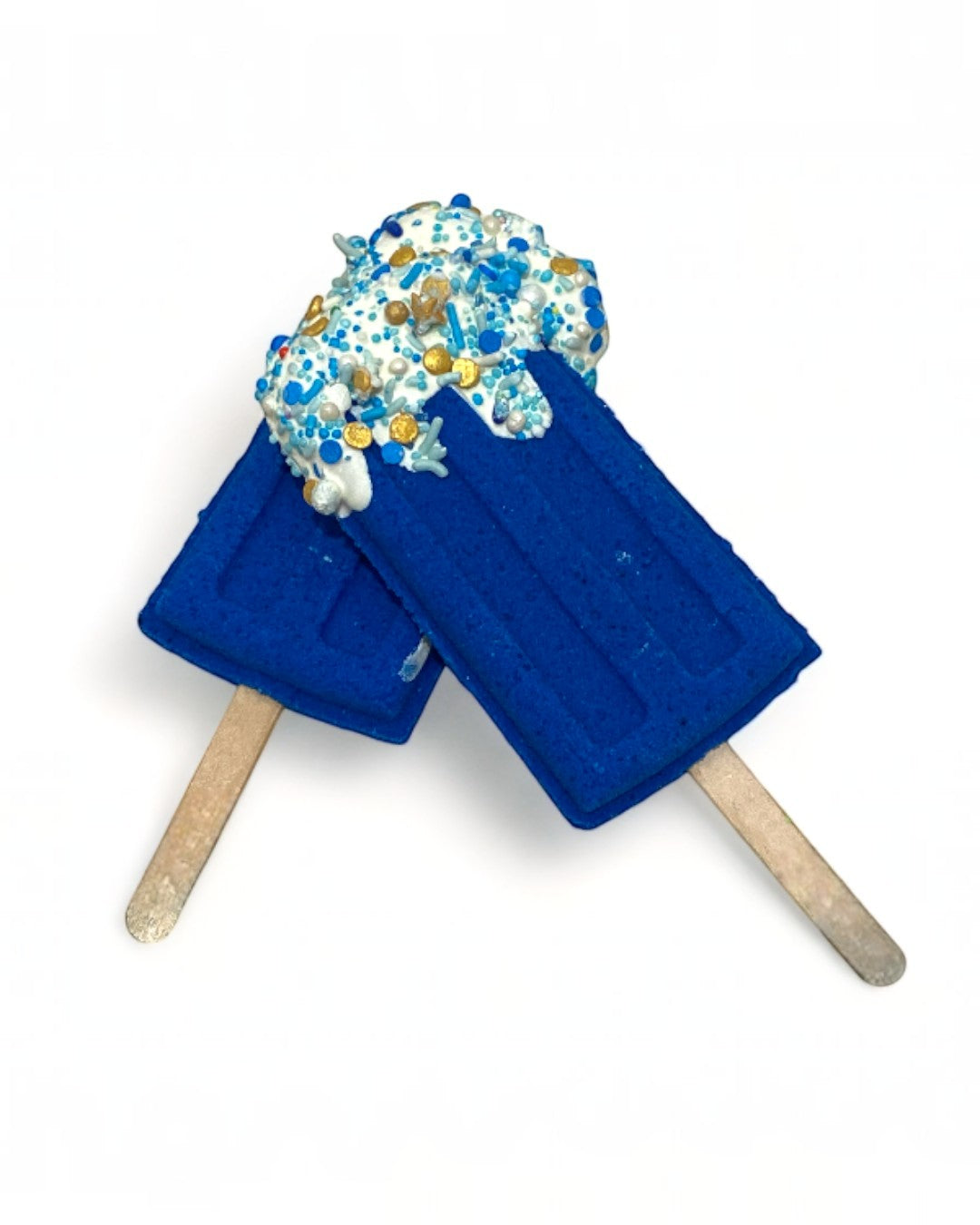 Two blue popsicle bath bombs against a white background