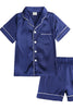 Blue satin pajama set with white piping on a white background