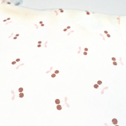 Pattern of red and pink cherries on a white background