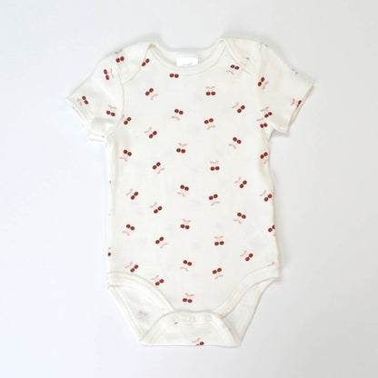 Baby onesie with cherry pattern on a white background