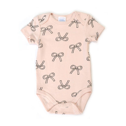 Baby onesie with bow pattern on a white background