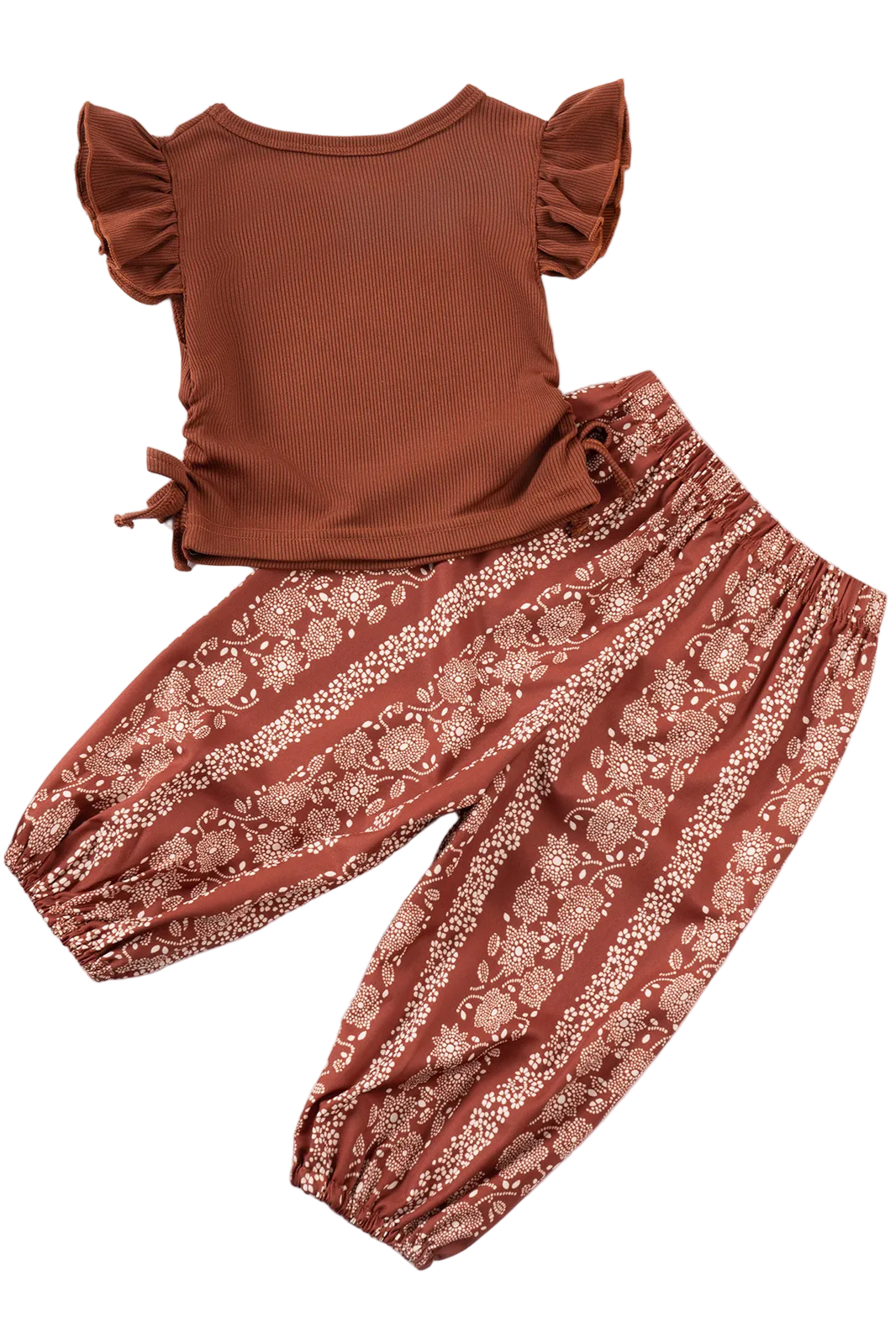 Brown top and floral pants set on a white background with yellow flowers.