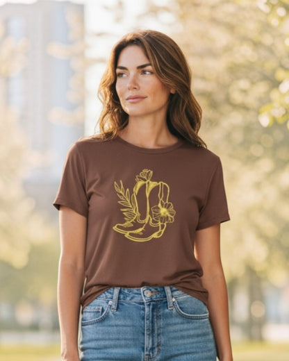 Woman wearing a brown t-shirt with a graphic design outdoors