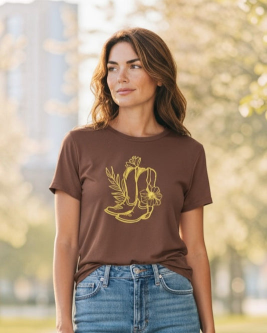 Woman wearing a brown t-shirt with a graphic design outdoors