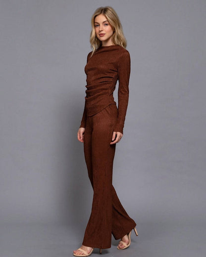 Woman wearing a brown outfit against a gray background