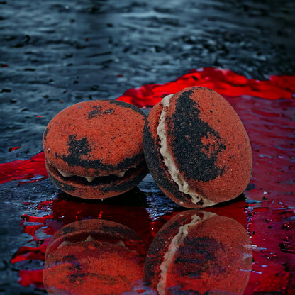 Two red and black dragons blood bath cookies against a black and red watery background