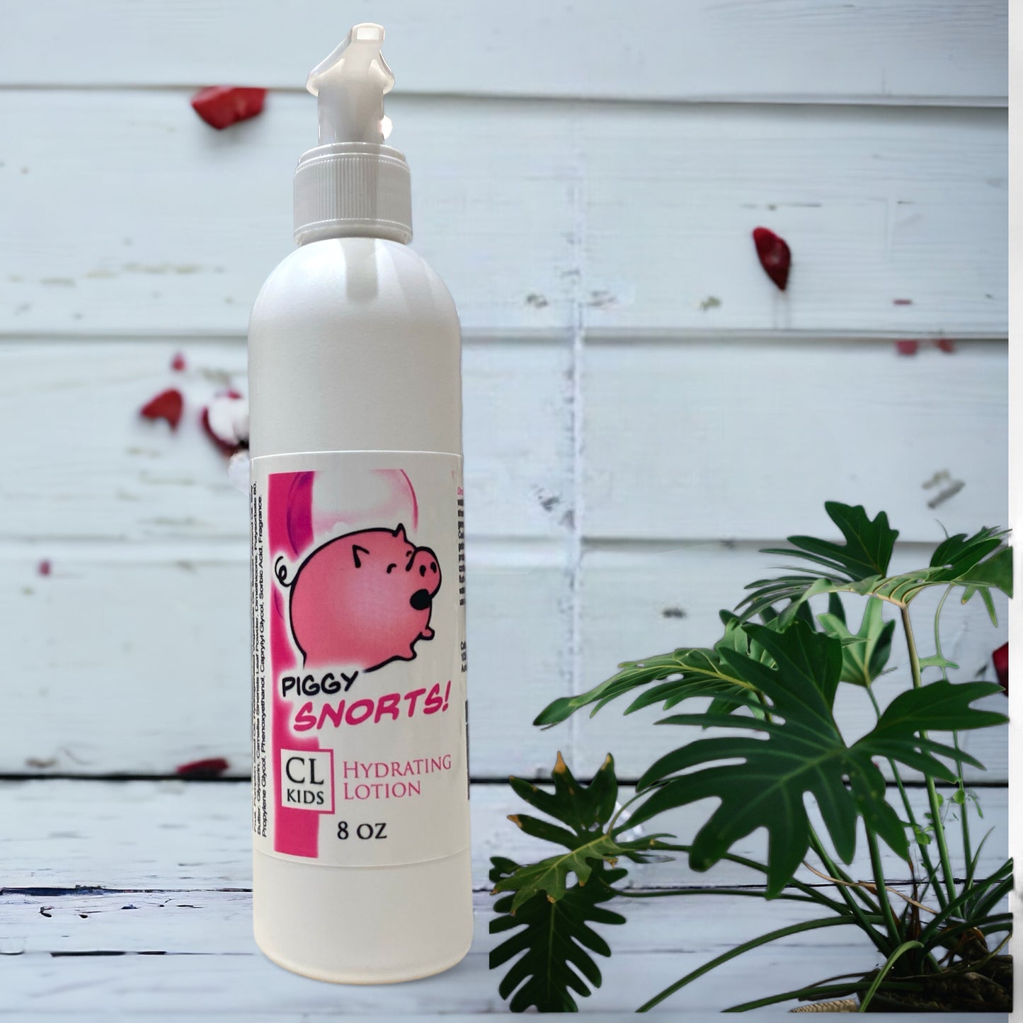 A white pump bottle of our piggy snorts body lotion against a wood background