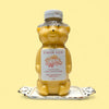 Bear-shaped honey bottle with 'Calla Lily' label on a yellow background
