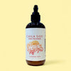 Bottle of Calla Lily Green Tea Lotion with a decorative label on a beige background