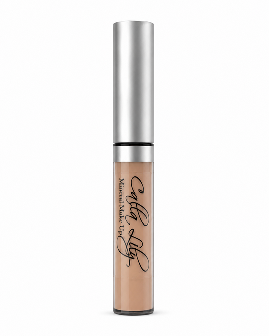 Cosmetic concealer with silver applicator on a white background
