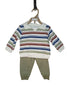 Children's outfit with striped shirt and green pants on a white surface