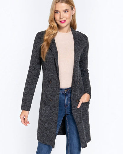 Woman wearing a gray coat over a beige top and blue jeans on a white background