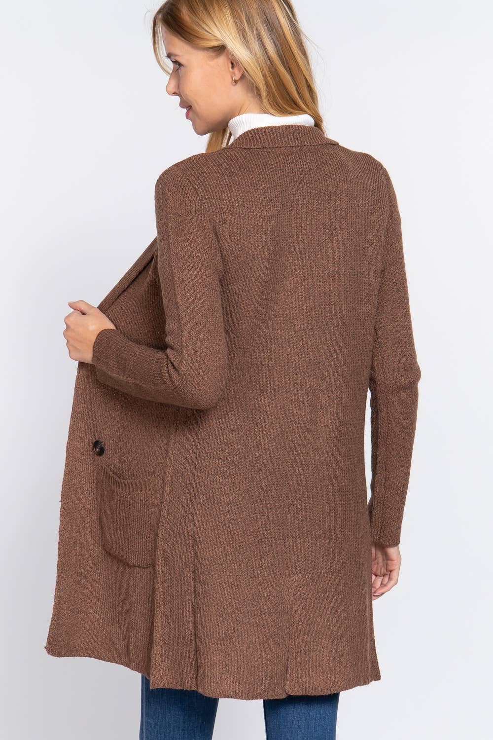 Woman wearing a brown cardigan on a white background