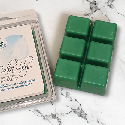 Green wax melts in a packaging on a marble surface