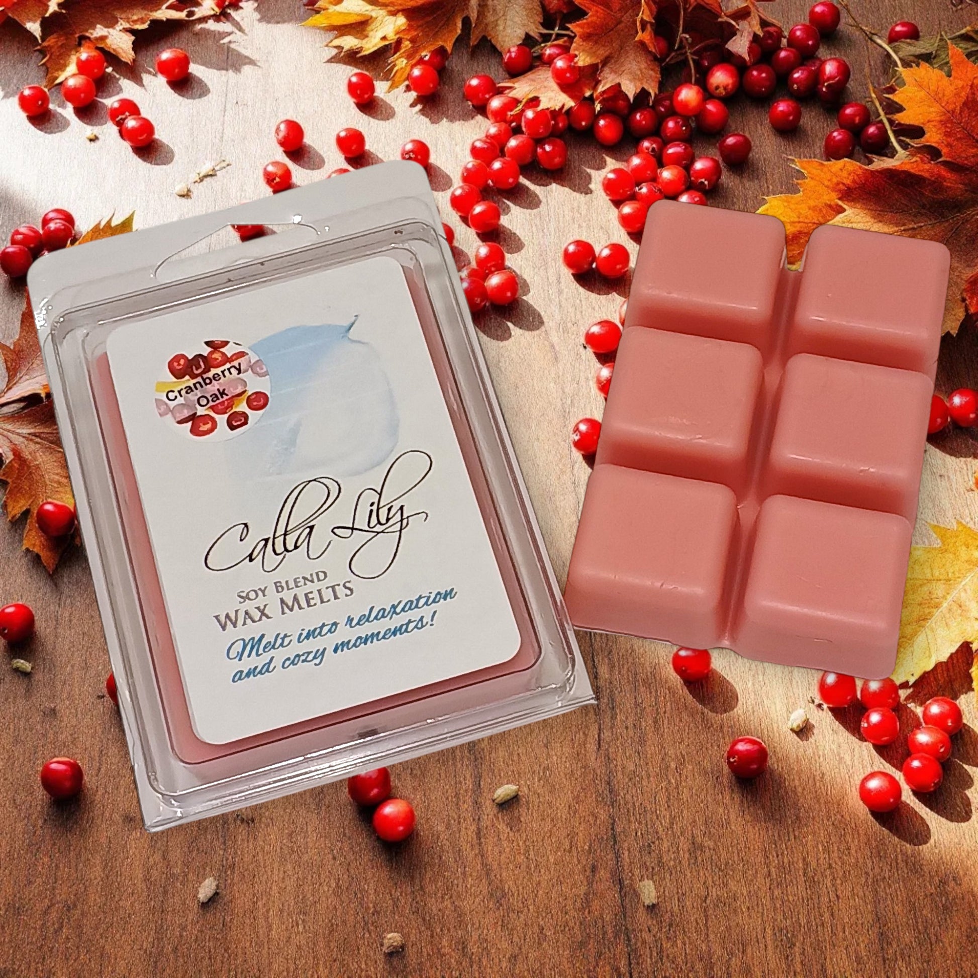 Candle Lily soy blend wax melts packaging with pink wax cubes on a wooden surface with red berries and autumn leaves.