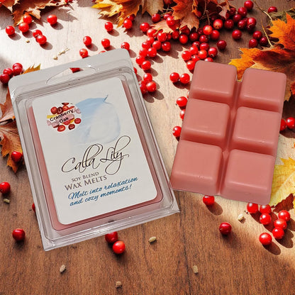 Candle Lily soy blend wax melts packaging with pink wax cubes on a wooden surface with red berries and autumn leaves.