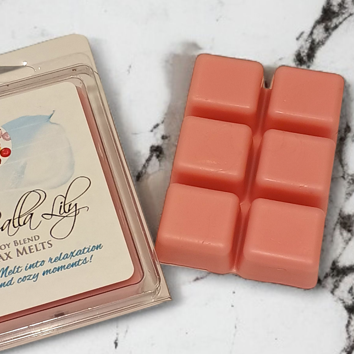 Calla Lily wax melts packaging with pink wax melts on a marble surface