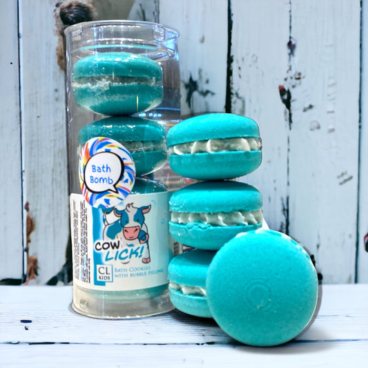 A stack of teal calla cow bath cookies and a full tube of them against a wood background