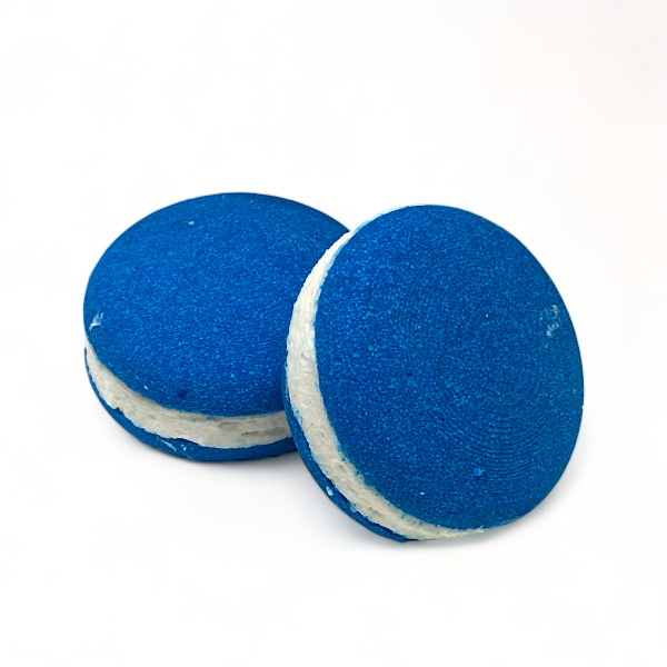 Two blue sheep bath cookies against a white background