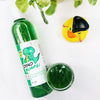 Dino Burps Shimmering Body Wash in a transparent bottle and cup of our green dino burps body wash against a white background