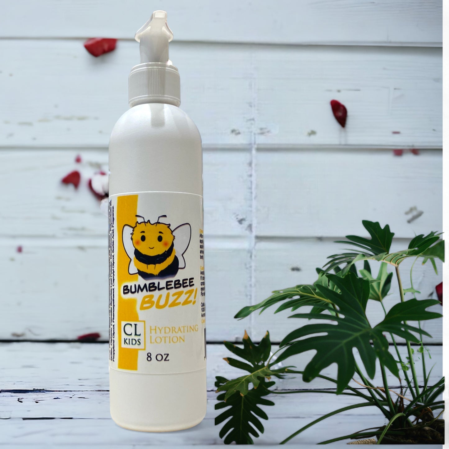 A white pump bottle of our bumblebee buzz body lotion against a wood background