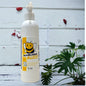 A white pump bottle of our bumblebee buzz body lotion against a wood background