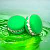 Two green dino burps bath cookies against a green watery background