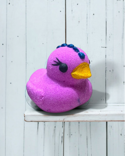 Calla Lily Cosmetics + CL kids purple duckie bath bomb with grape scent, coconut oil, and cocoa butter.