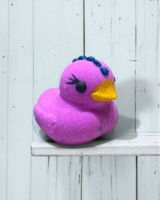 Calla Lily Cosmetics + CL kids purple duckie bath bomb with grape scent, coconut oil, and cocoa butter.