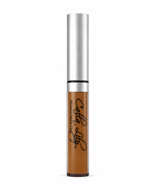 Cosmetic tube with silver cap and brown body on a white background