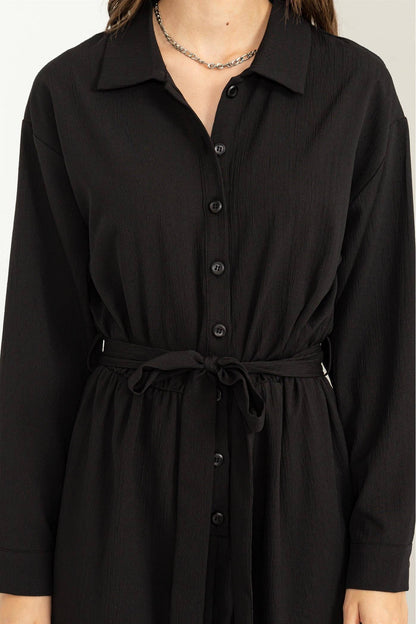 Black dress with a belt on a white background