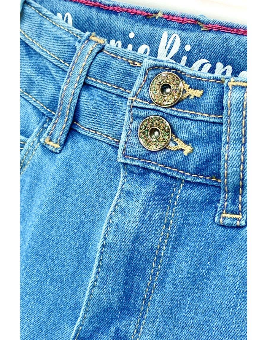 Close-up of blue denim jeans with brand name on pocket